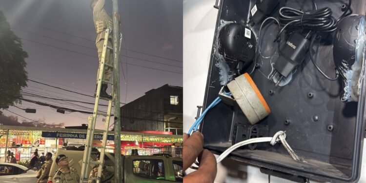 foto de policial militar removendo câmera clandestina de poste em rua do bairro de Valéria em Salvador